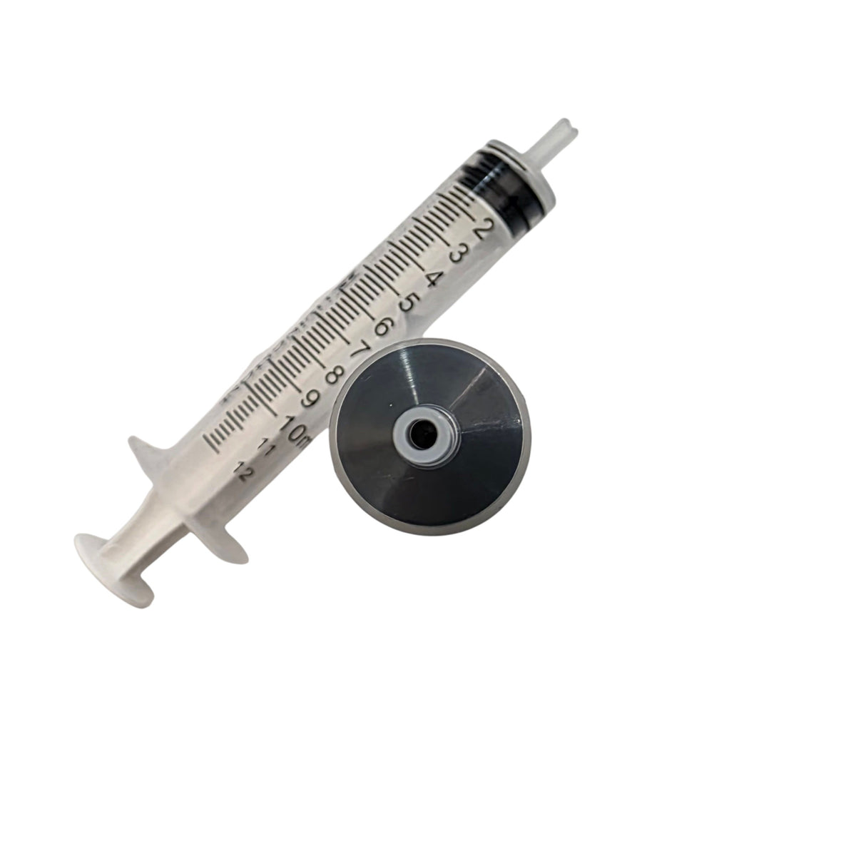 A 10mL clear plastic concentric syringe , shown alongside the central concentric syringe tip, on a plain white background.