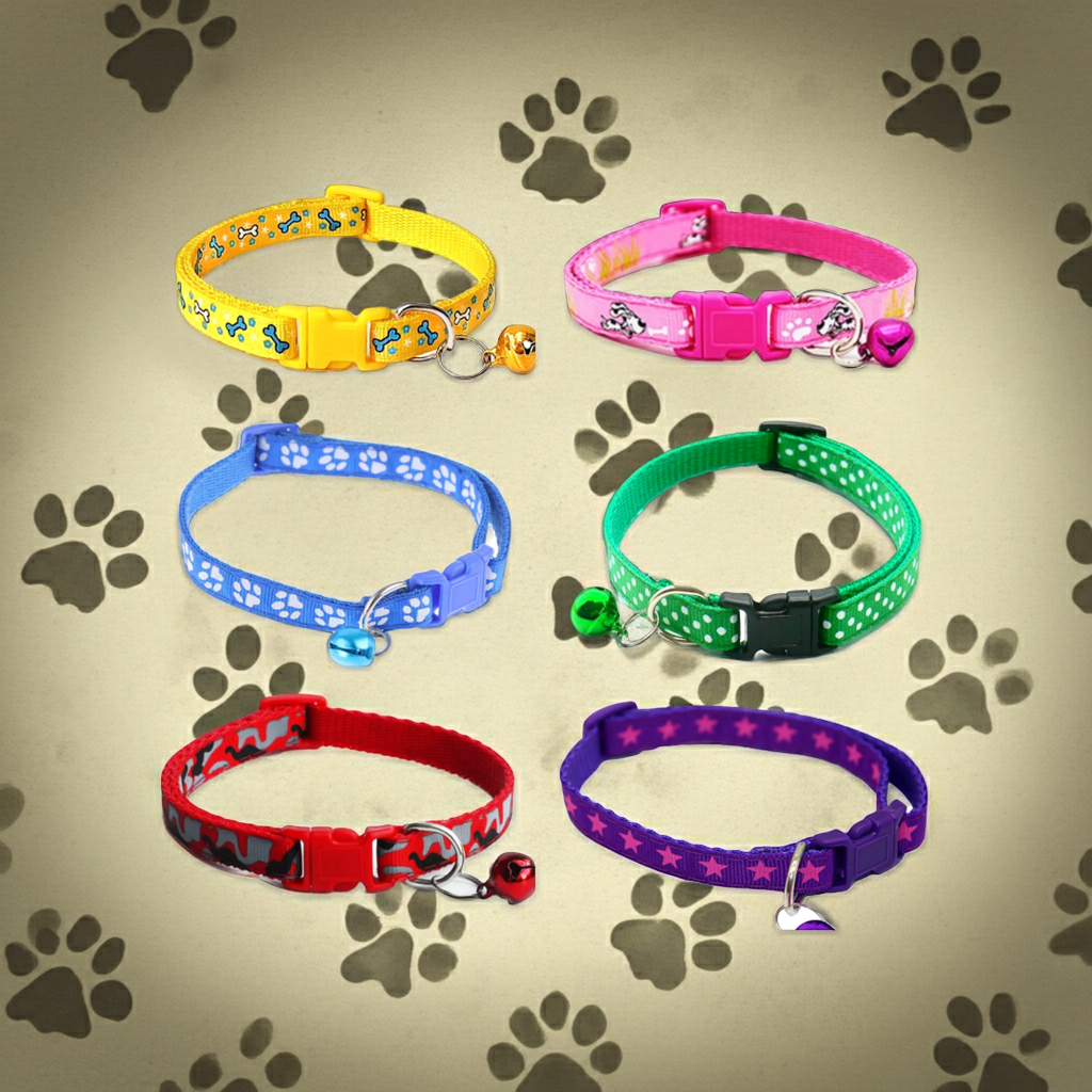 Set of colorful pet collars with paw prints on a beige background