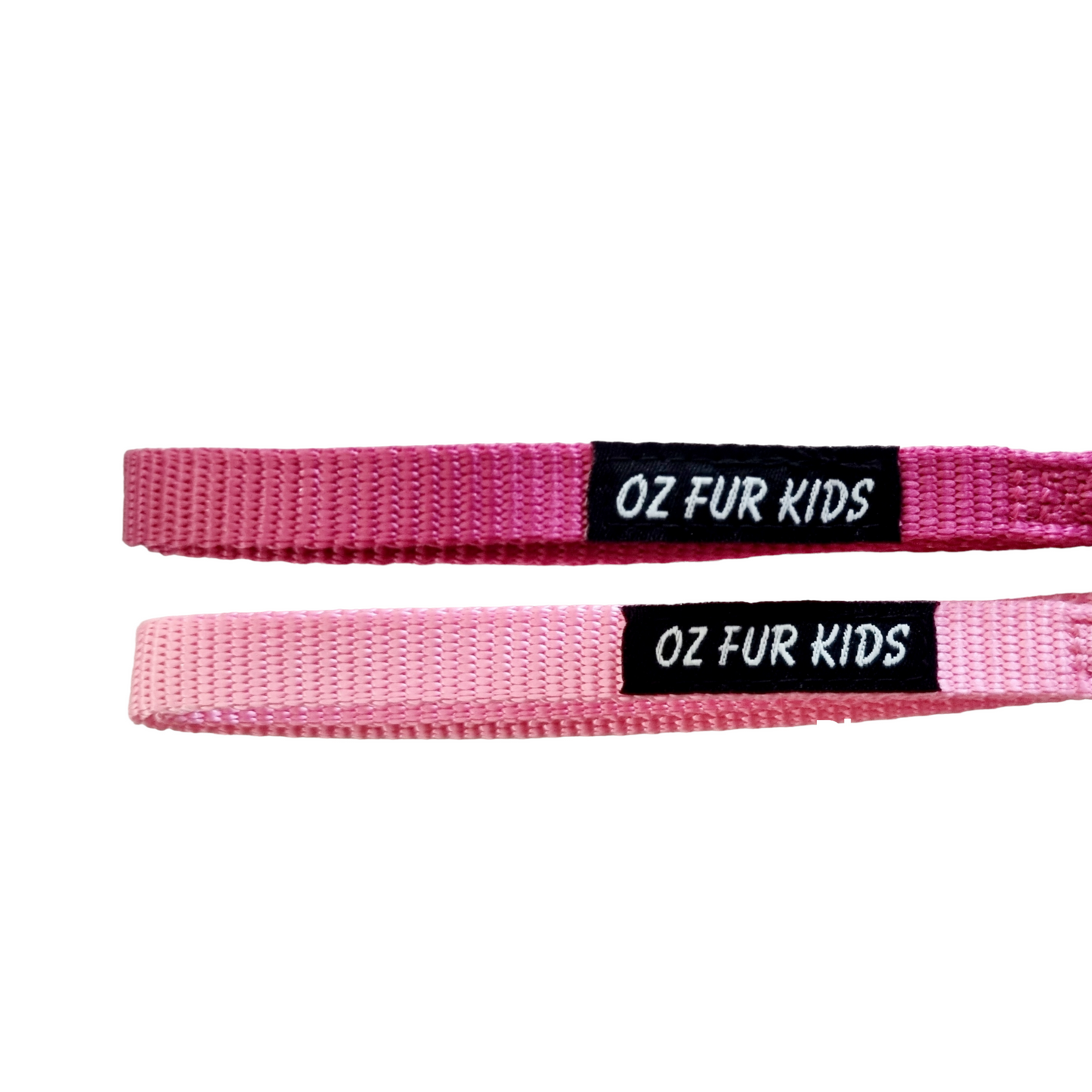 Two pink dog leashes with 'OZ FUR KIDS' labels on a white background