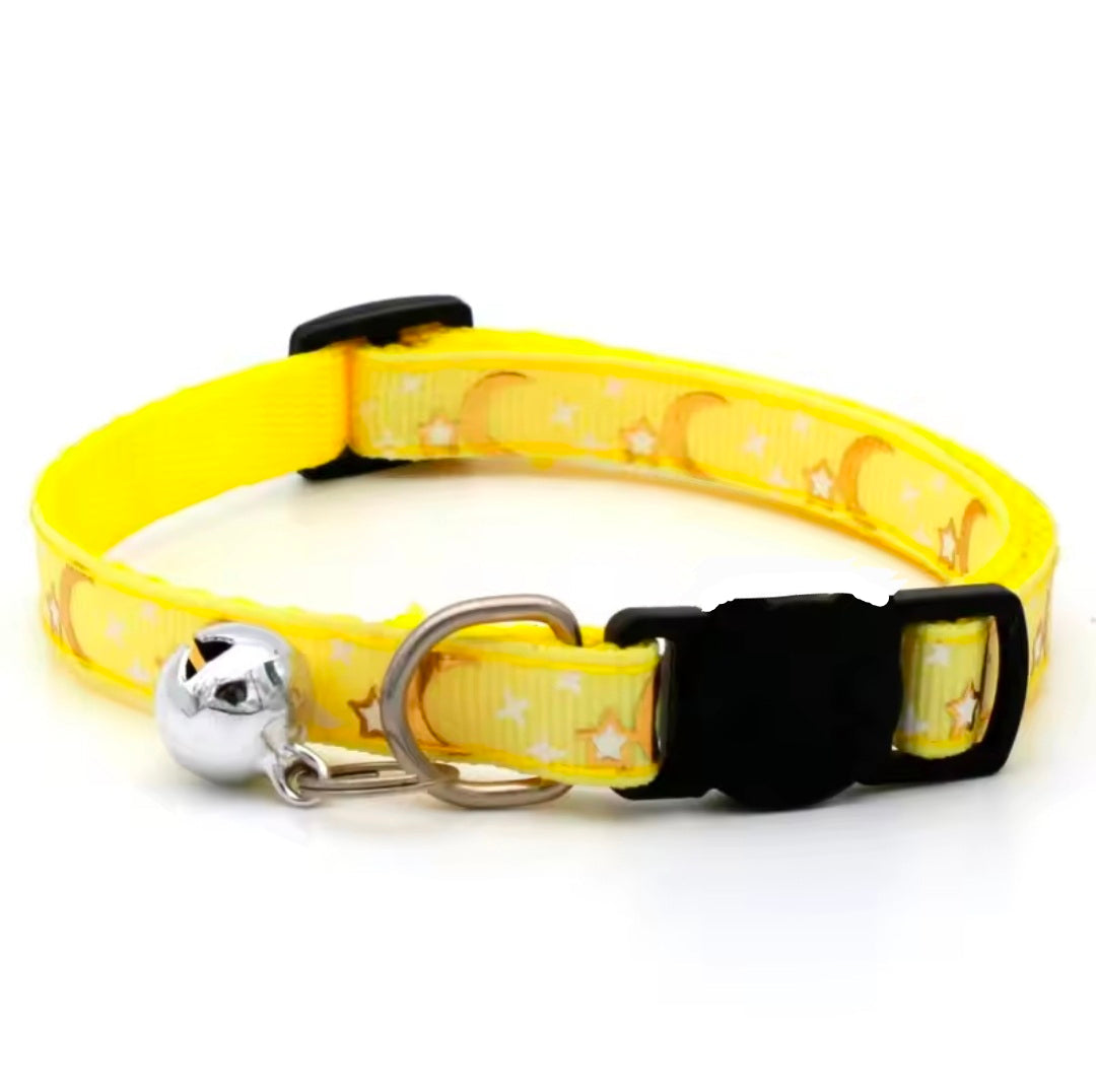 Yellow cat collar with black buckle and silver bell on a white background
