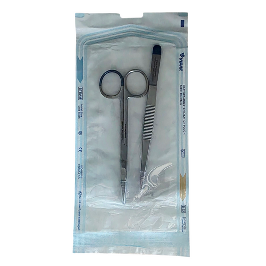 Pair of scissors and tweezers for suture removal in a clear plastic package on a white background 