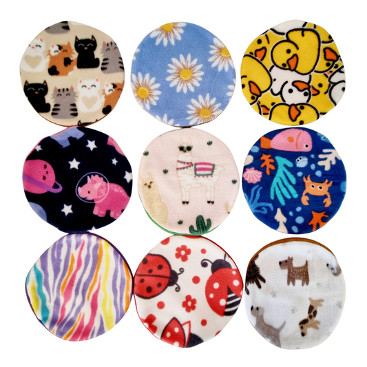 A collection of AFP & Snugglesafe Microwave Heat pad Covers, featuring different patterns such as animals, flowers, and geometric designs.