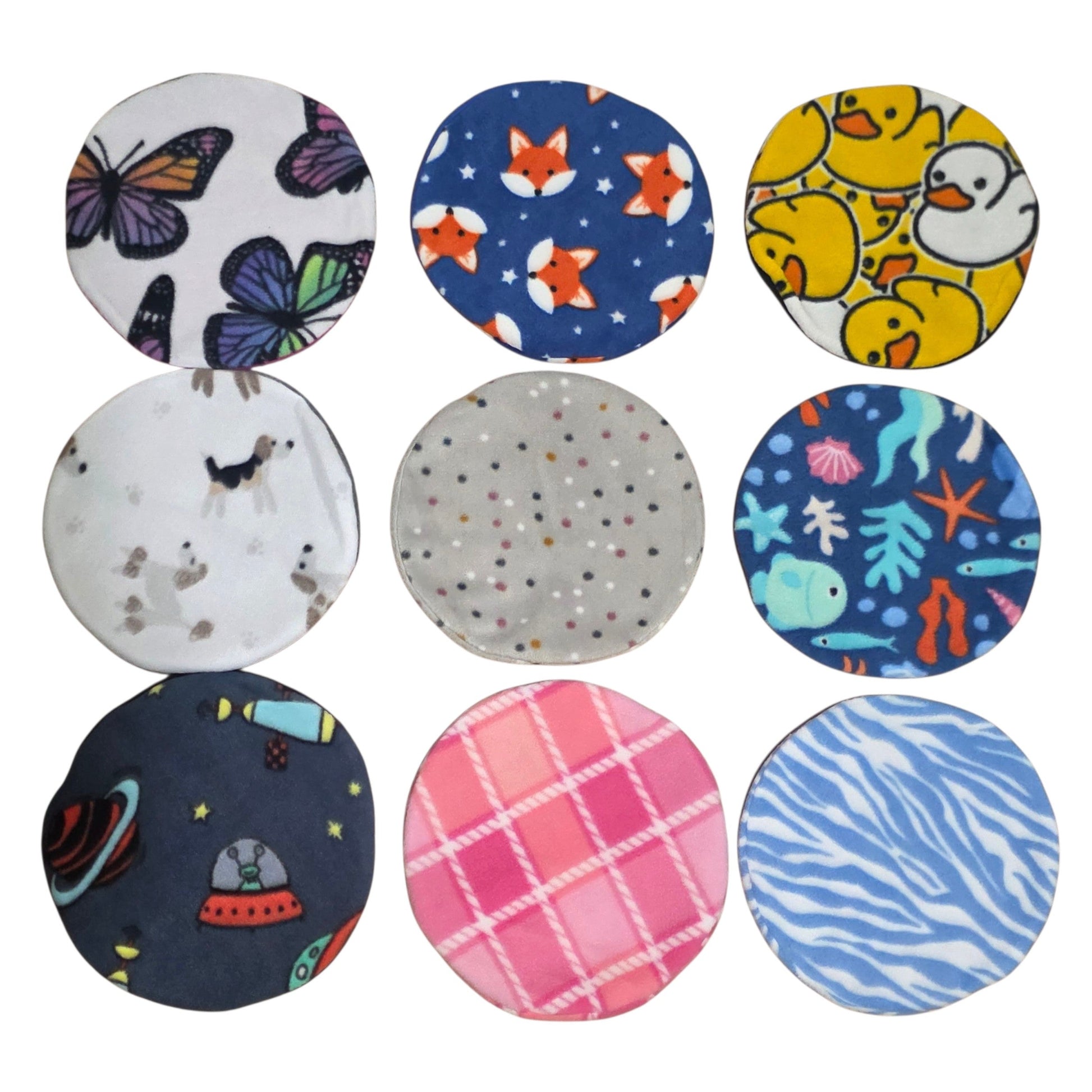 Collection of AFP and Snugglesafe Microwave Heat Pad Covers with various patterns on a white background