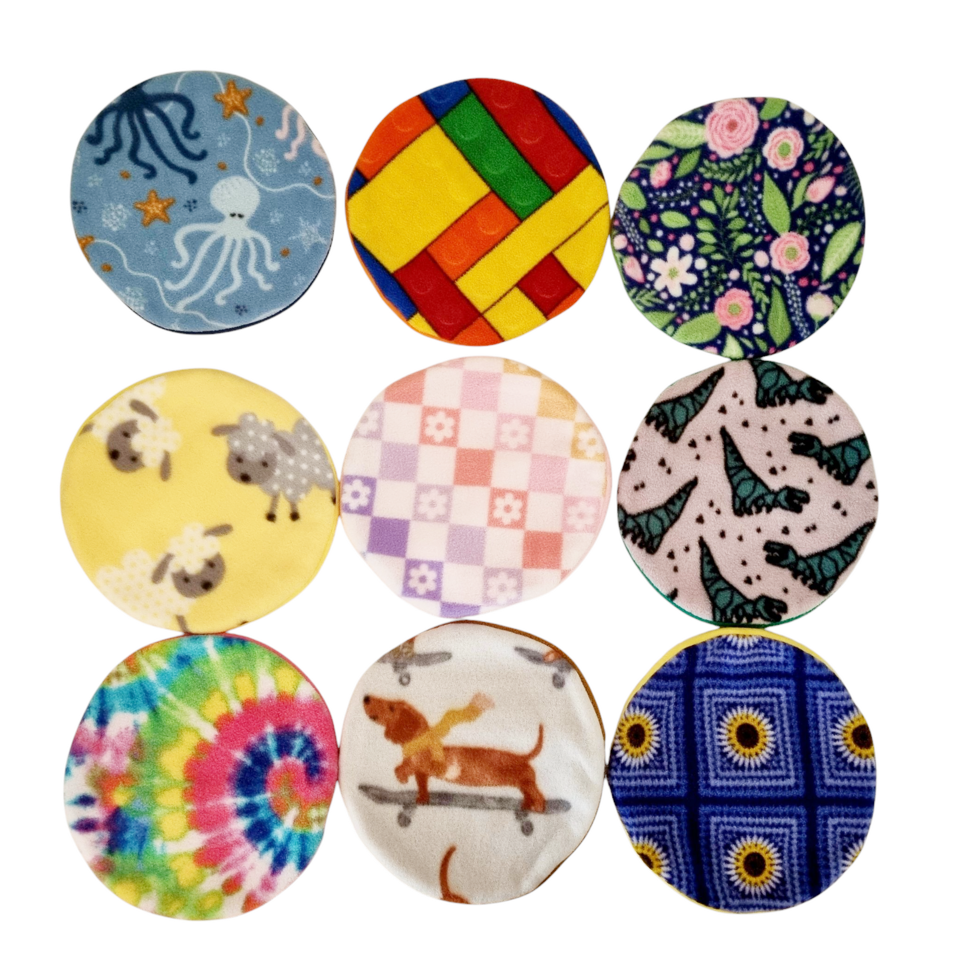 A collection of AFP & Snugglesafe Microwave Heat pad Covers, featuring different patterns such as animals, flowers, and geometric designs.