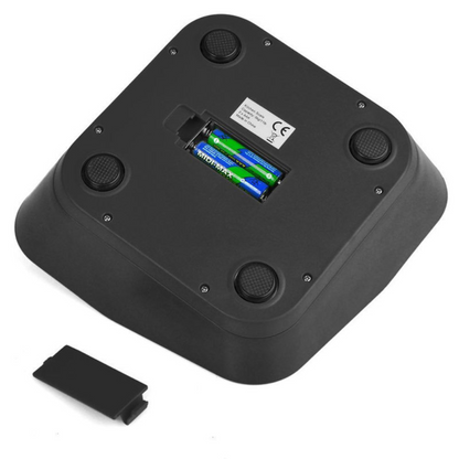 Black weigh scales with battery compartment on a white background