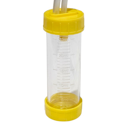 A clear plastic measuring chamber with yellow screw-on caps and two white tubes inserted at the top, shown on a plain white background.