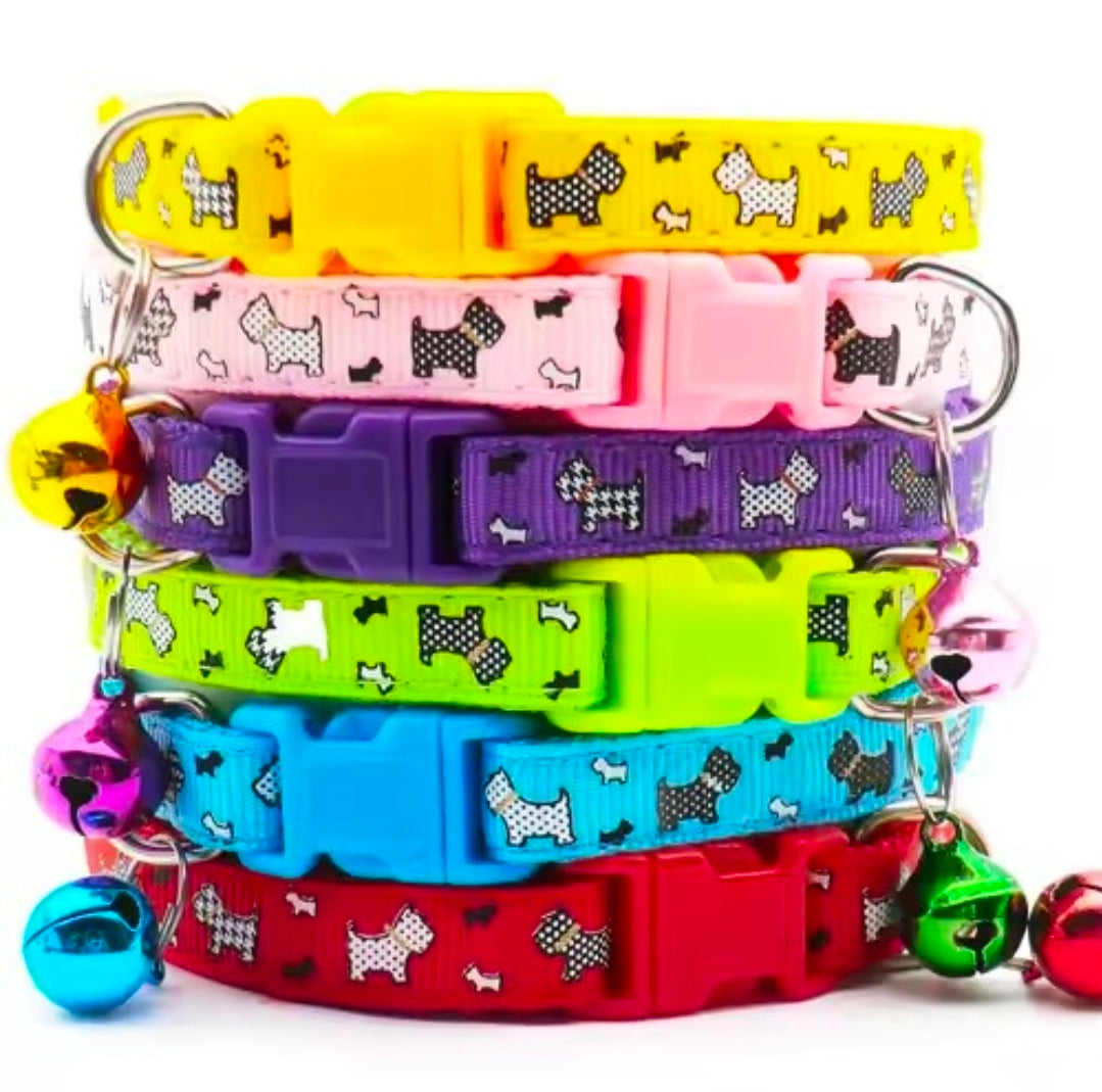 Stack of colorful pet collars with bell charms on a white background