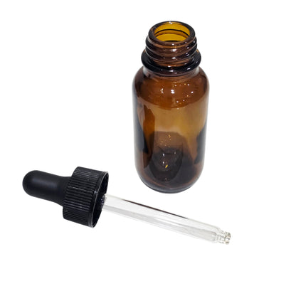 Brown glass dropper bottle with black cap on a white background