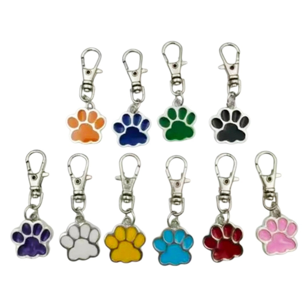 Set of colorful paw print keychains on a white background