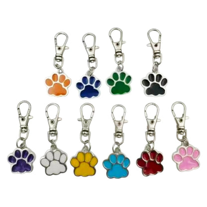 Set of colorful paw print keychains on a white background