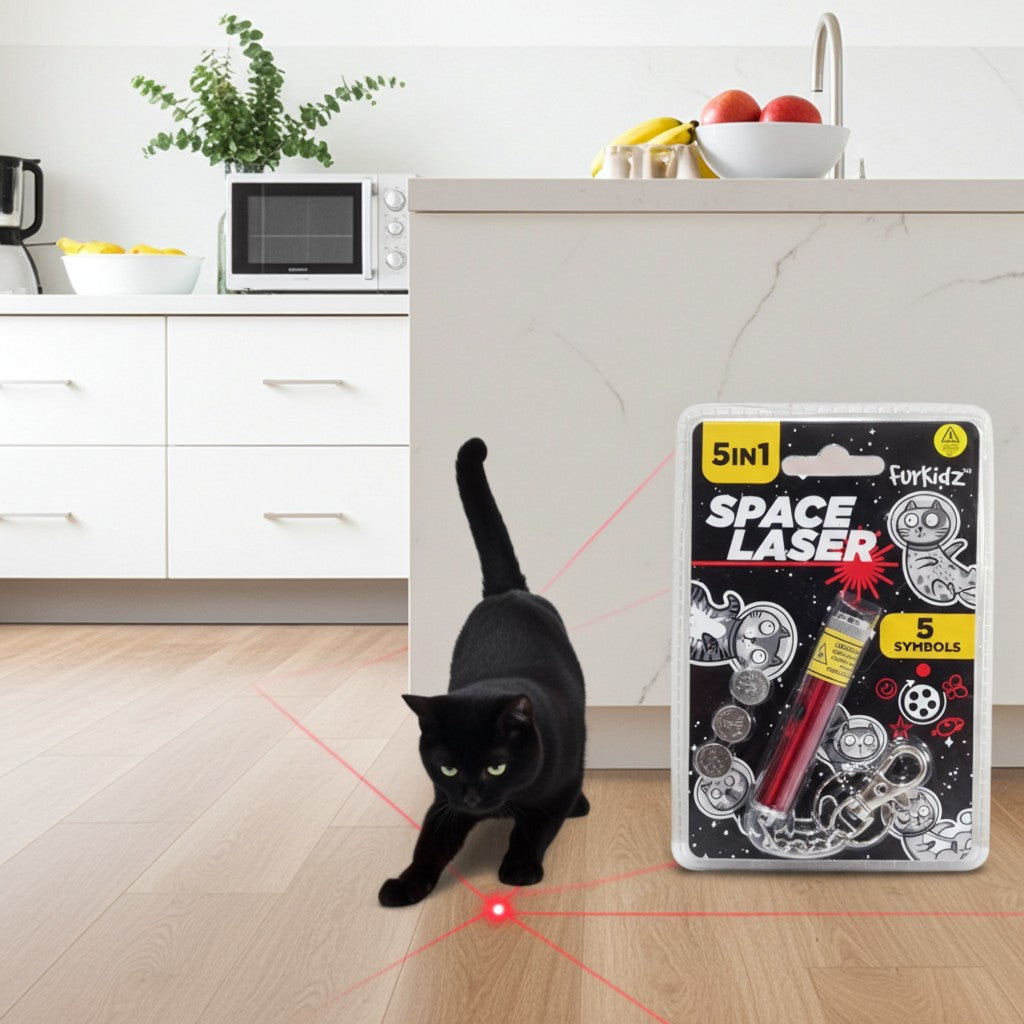 Black cat playing with a FurKidz Space Laser 5 Symbols space laser toy package in a kitchen.