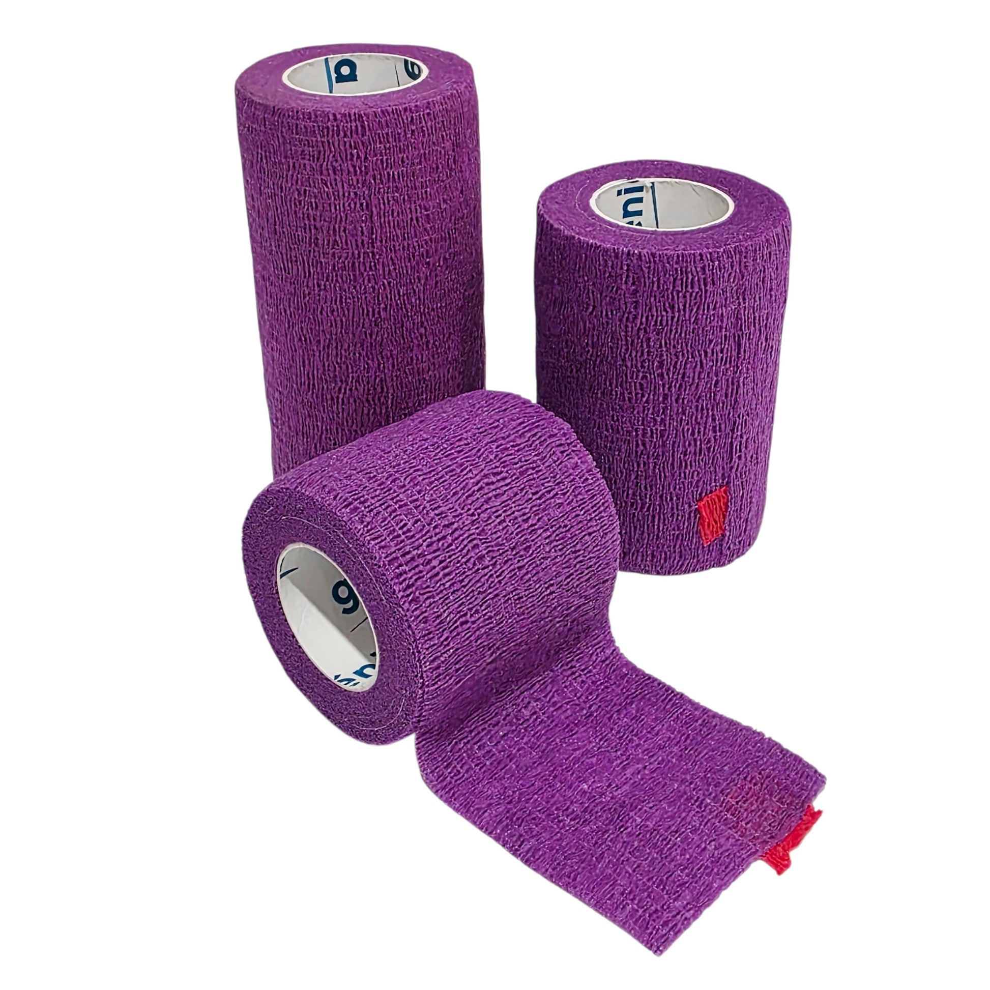 Three rolls of purple Genia Bitter Cohesive Bandage tape with one roll partially unrolled, showing the textured fabric and red brand tab on a white background.