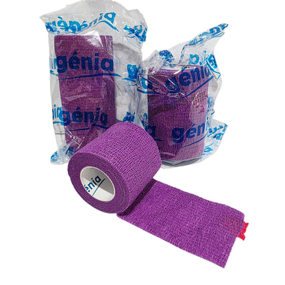Purple Genia Bitter Cohesive Bandage athletic, with one unrolled in front and two packaged rolls behind on a white background. The brand name 'Génia' is visible on the tape and packaging.
