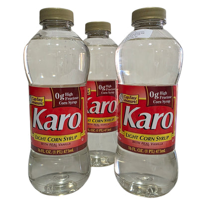 Three bottles of Karo Light Corn Syrup on a white background