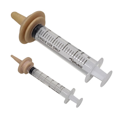 Two luer lock syringes with Miracle Nipples on a white background