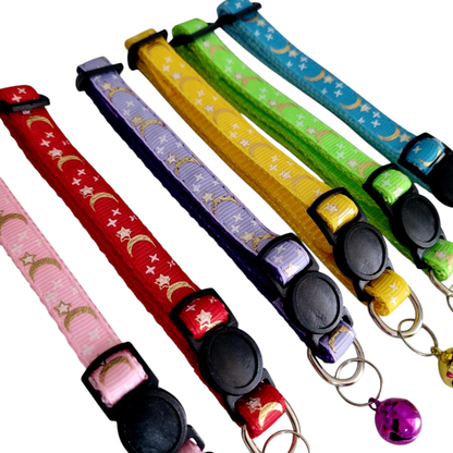 A collection of colorful cat collars with a stars and moons pattern, featuring break-away clasps and bells.