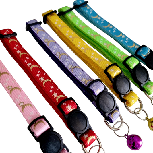 A collection of colorful cat collars with a stars and moons pattern, featuring break-away clasps and bells.