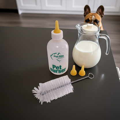 Pet nursing bottle with accessories on a table, with a dog in the background.