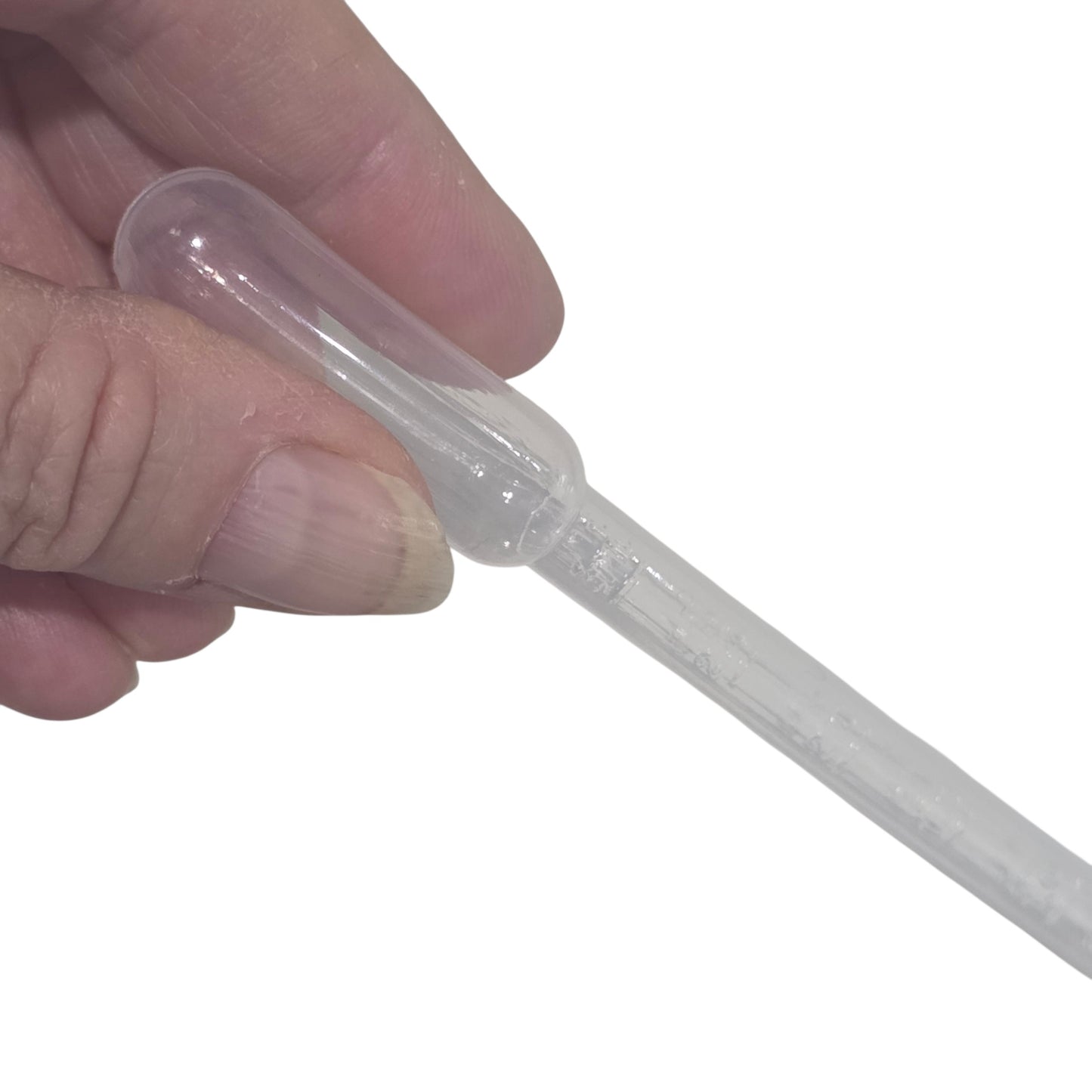 Hand holding a clear plastic syringe on a white background