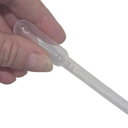 Hand holding a clear plastic syringe on a white background