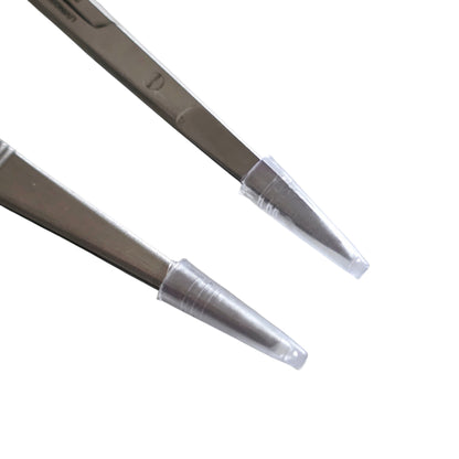 Safety plastic caps on surgical instruments on a white background