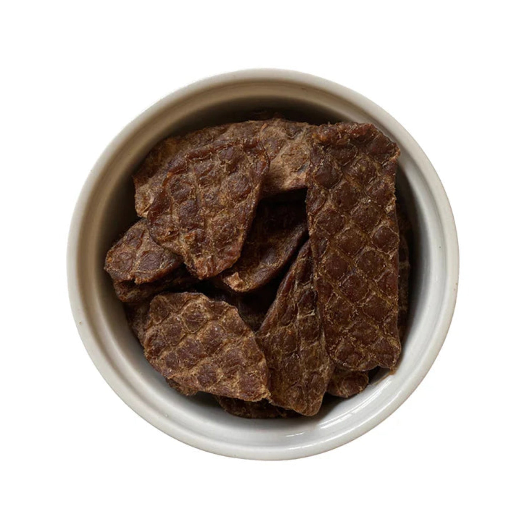 Prime 100 Breakable Treat Pieces in a small metal bowl on a white background