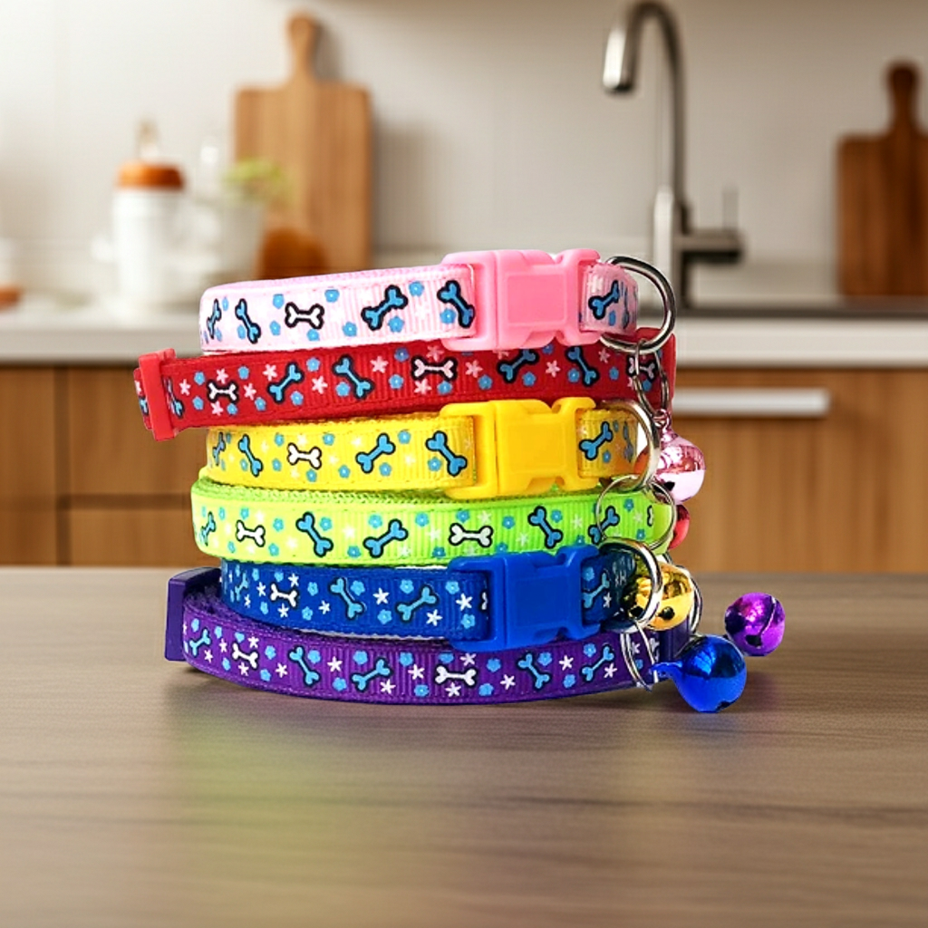 Stack of colorful dog collars with bone pattern on a kitchen counter.