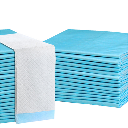 Stacks of blue puppy pads with adhesive tape corners, designed for pets.