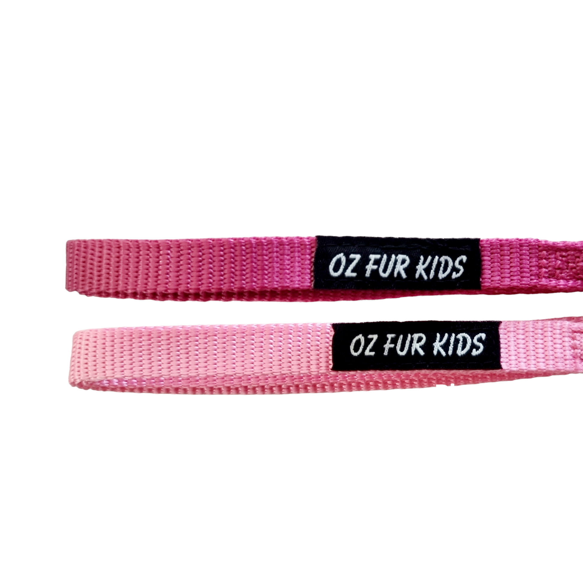 Two pink dog leashes with 'OZ FUR KIDS' labels on a white background