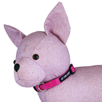 Pink glittery dog toy with a pink collar on a white background