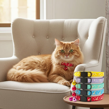 Orange cat lying on a beige armchair with colorful cat collars on a small table beside it.