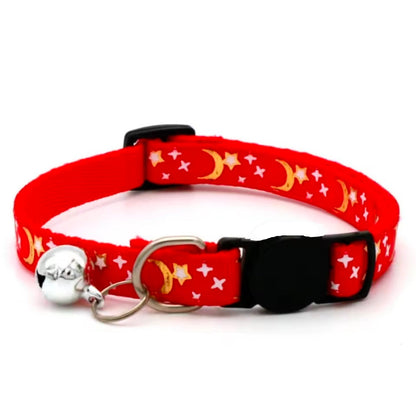 Red cat collar with star and moon pattern on a white background