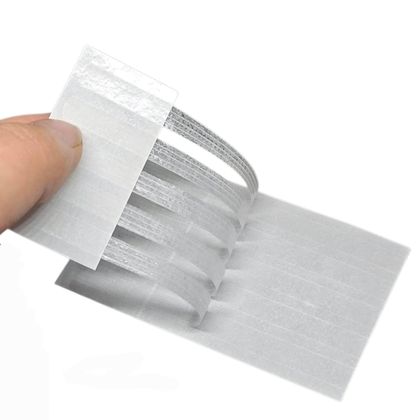 Steri Strips held by a hand on a white background