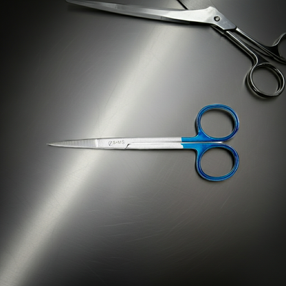 Two pairs of scissors, one with blue handles and the other with black handles, on a reflective surface.