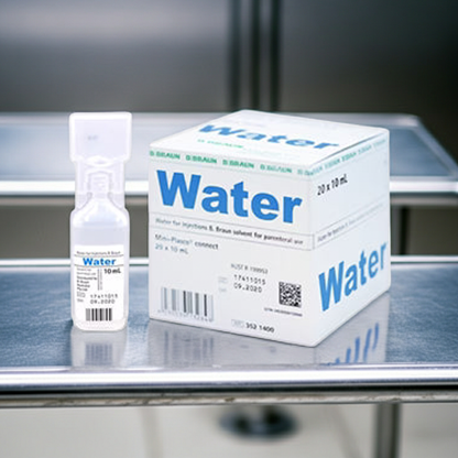Box and ampule labeled 'Water' on a stainless surface with a blurred background