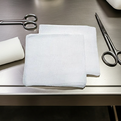 Guaze Swabs with White bandages and scissors on a metallic surface