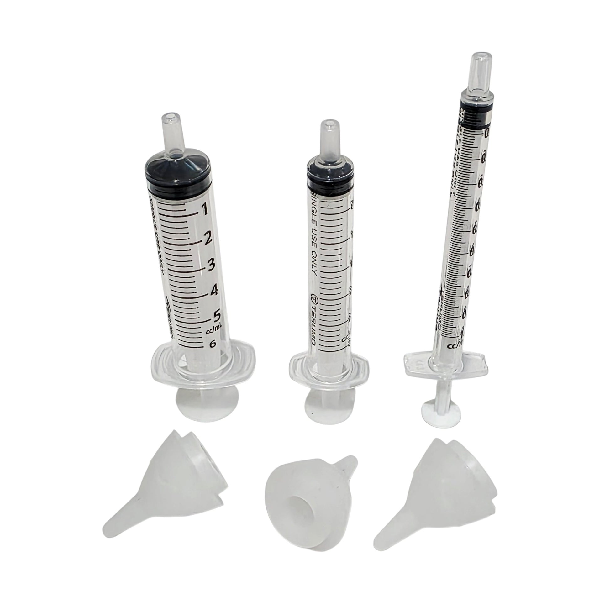 Three clear plastic syringe shown with three SuckleSoft Teats on a plain white background.