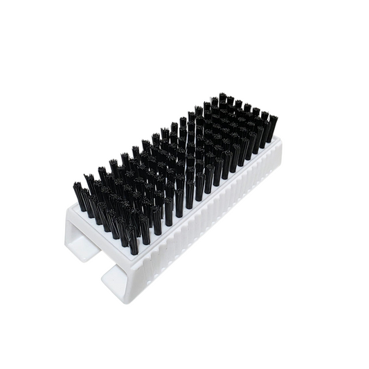 White surgical scrub brush with black bristles on a white background