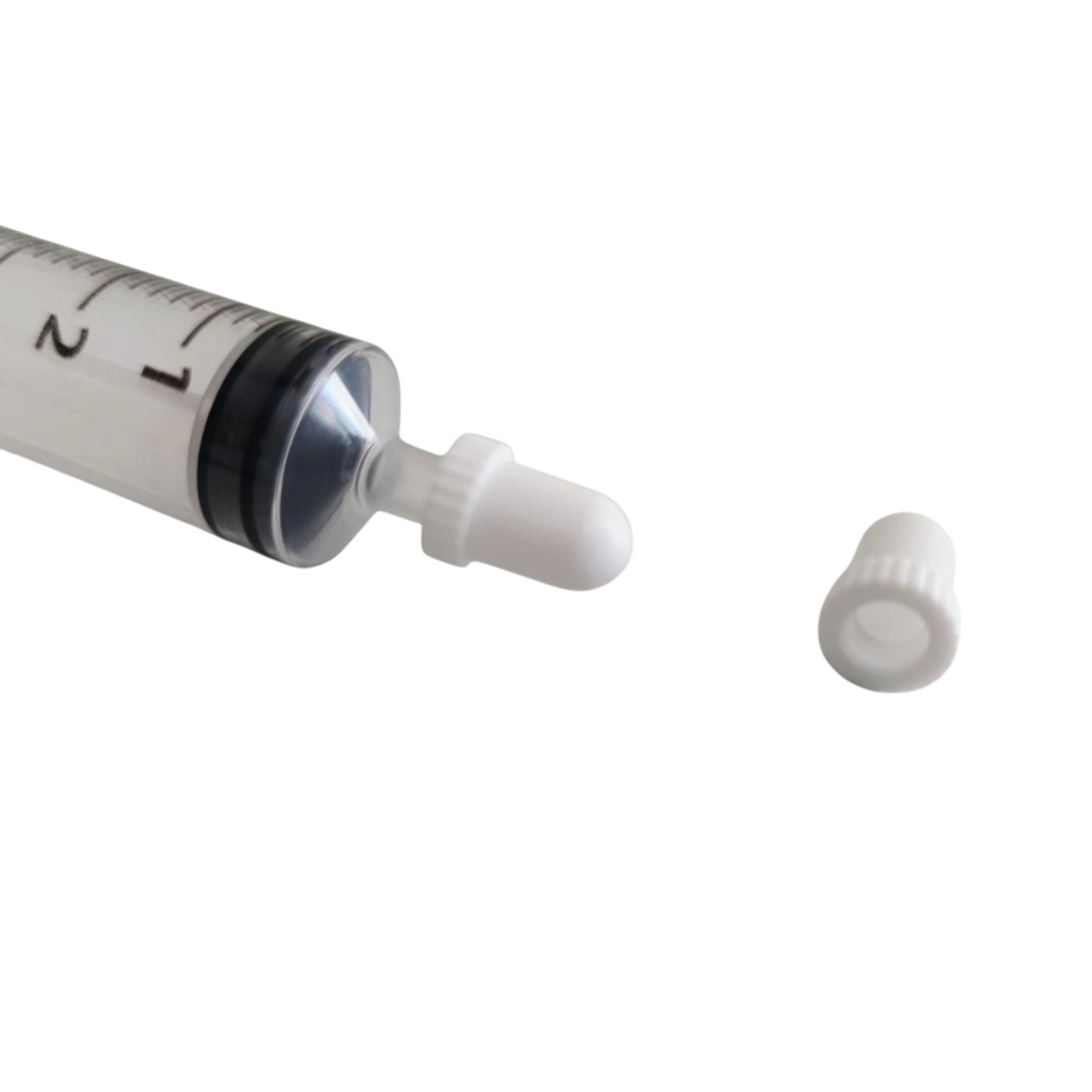 Close Up of a Syringe cap on a syringe on a white background