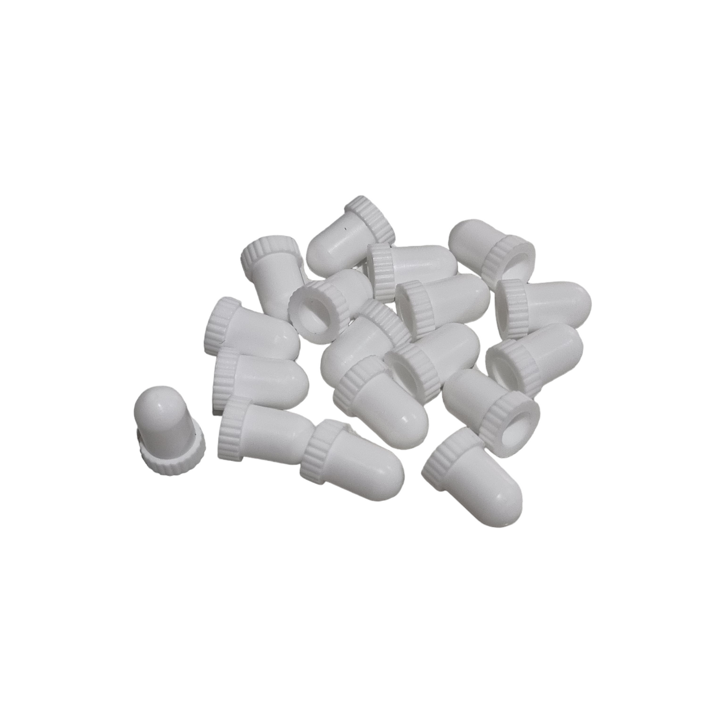 A collection of white, non-sterile syringe caps gathered together.