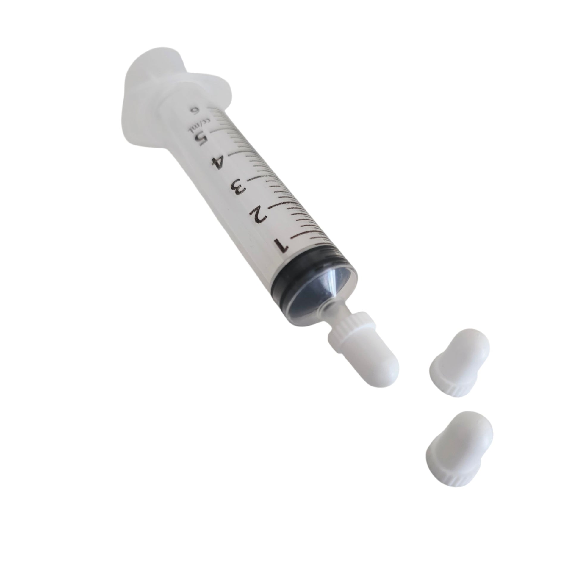 Syringe with syringe caps on a white background