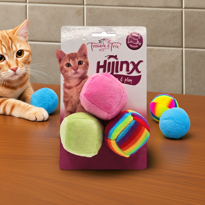 Trouble & Trix Hijinx Cat toy package with colorful balls and a cat looking at the camera on a wooden surface.