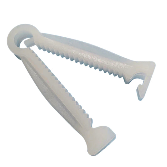 A white plastiUmbilical Cord Clamp shown on a plain white background.