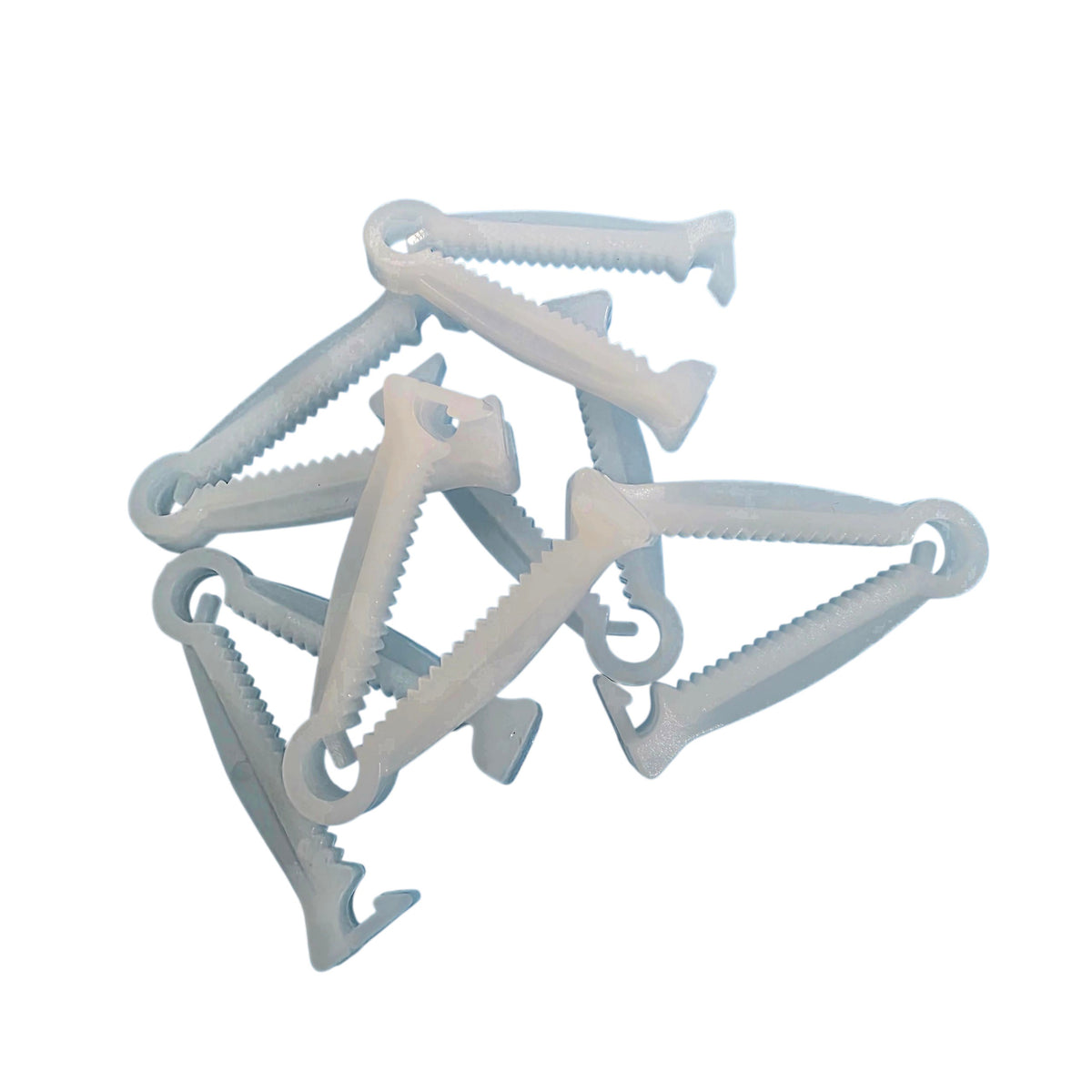 A pile of white plastic Umbilical Cord Clamps arranged on a plain white background.