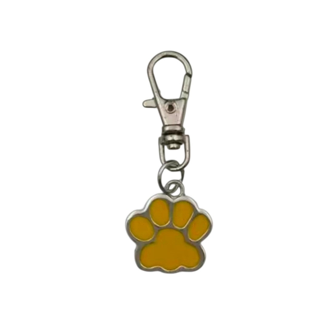 Yellow paw print keychain with a metal clasp on a white background