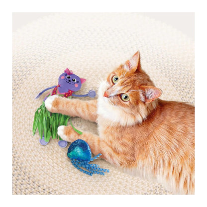 Cat playing with a colorful KONG Hula cat toy on a textured surface