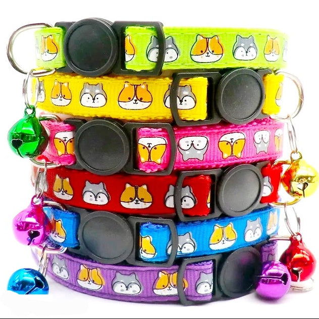 A stack of multicolored cat-patterned break-away cat collars with bells.
