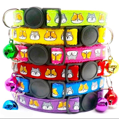 A stack of multicolored cat-patterned break-away cat collars with bells.