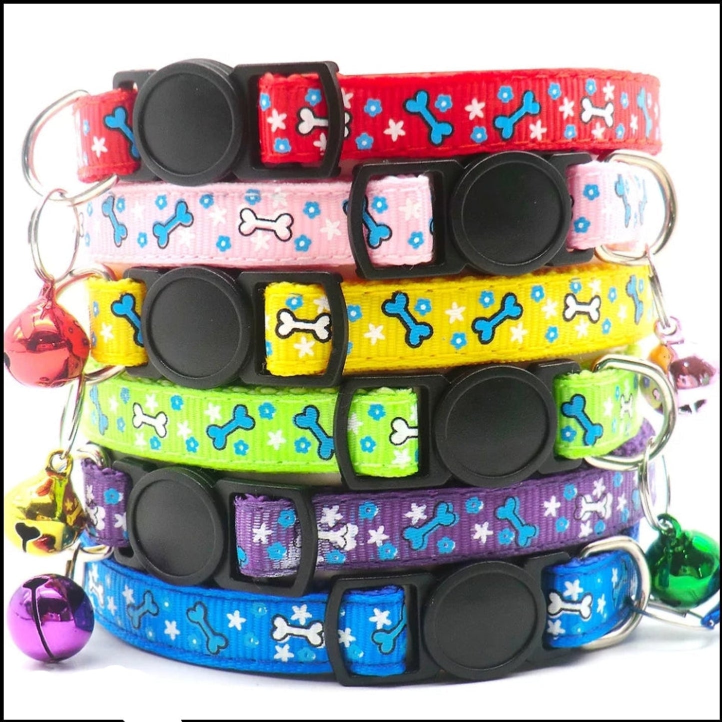 Stack of colorful dog collars with bone and star patterns on a white background