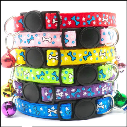 Stack of colorful dog collars with bone and star patterns on a white background